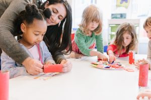 Teacher instructing children at the West Campus at ABS Preschool.