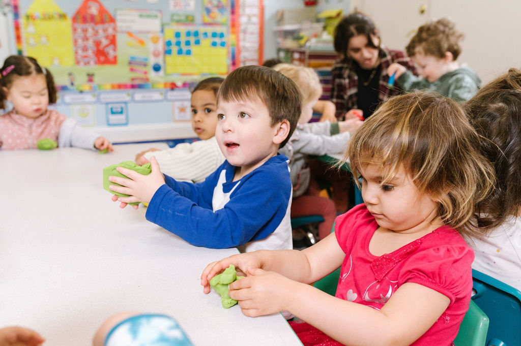 Kids playing with modeling clay at a table
