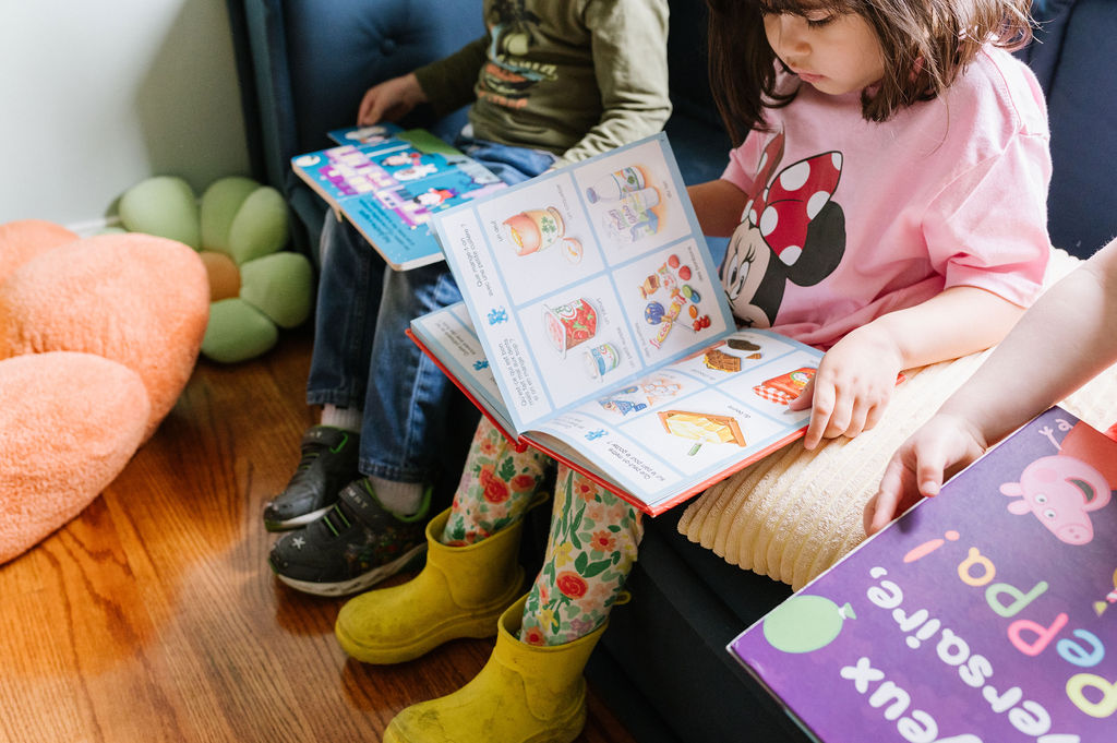 Girl reading a book in French.