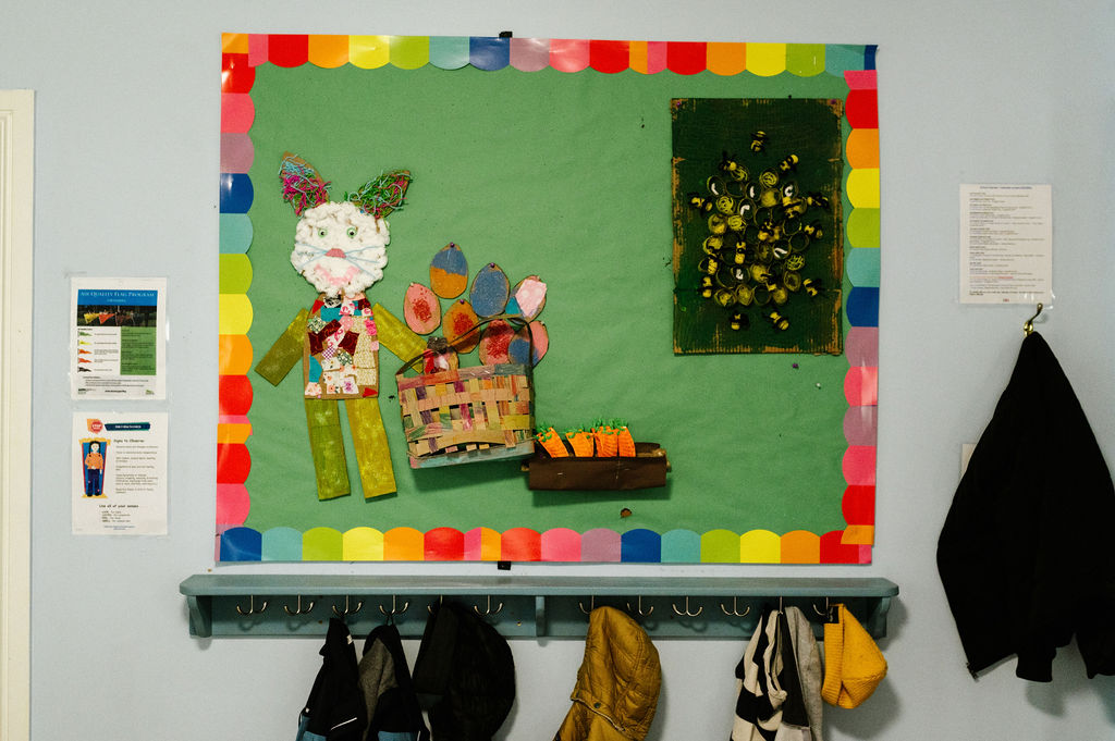 Preschool artwork pinned on the wall.