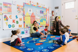 Children playing in preschool with teachers.