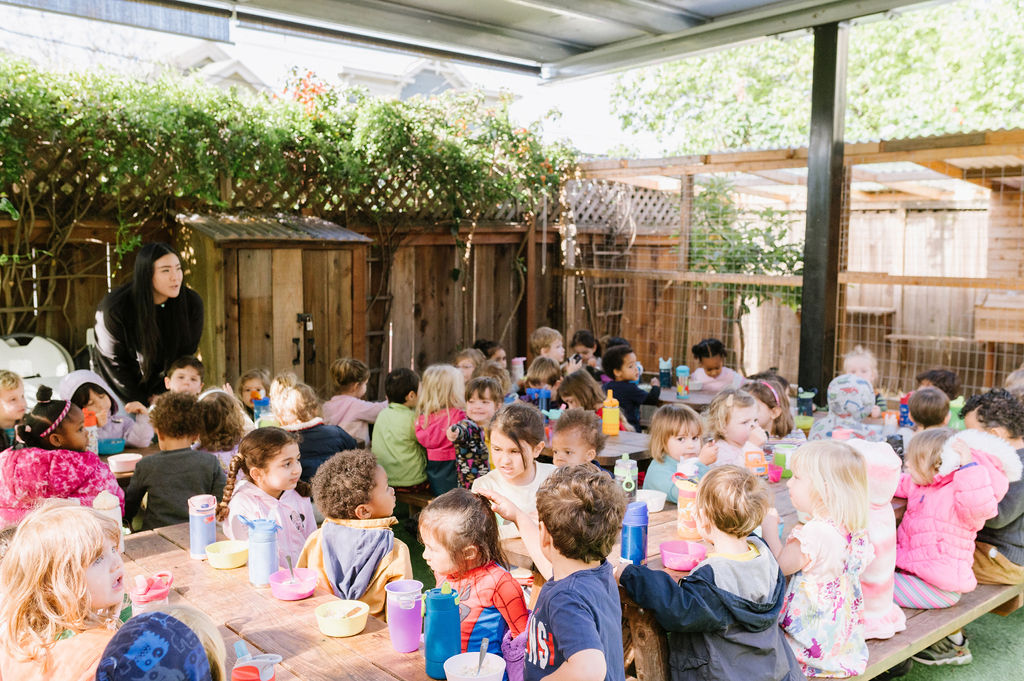 Children in French immersion preschool sitting around a table.