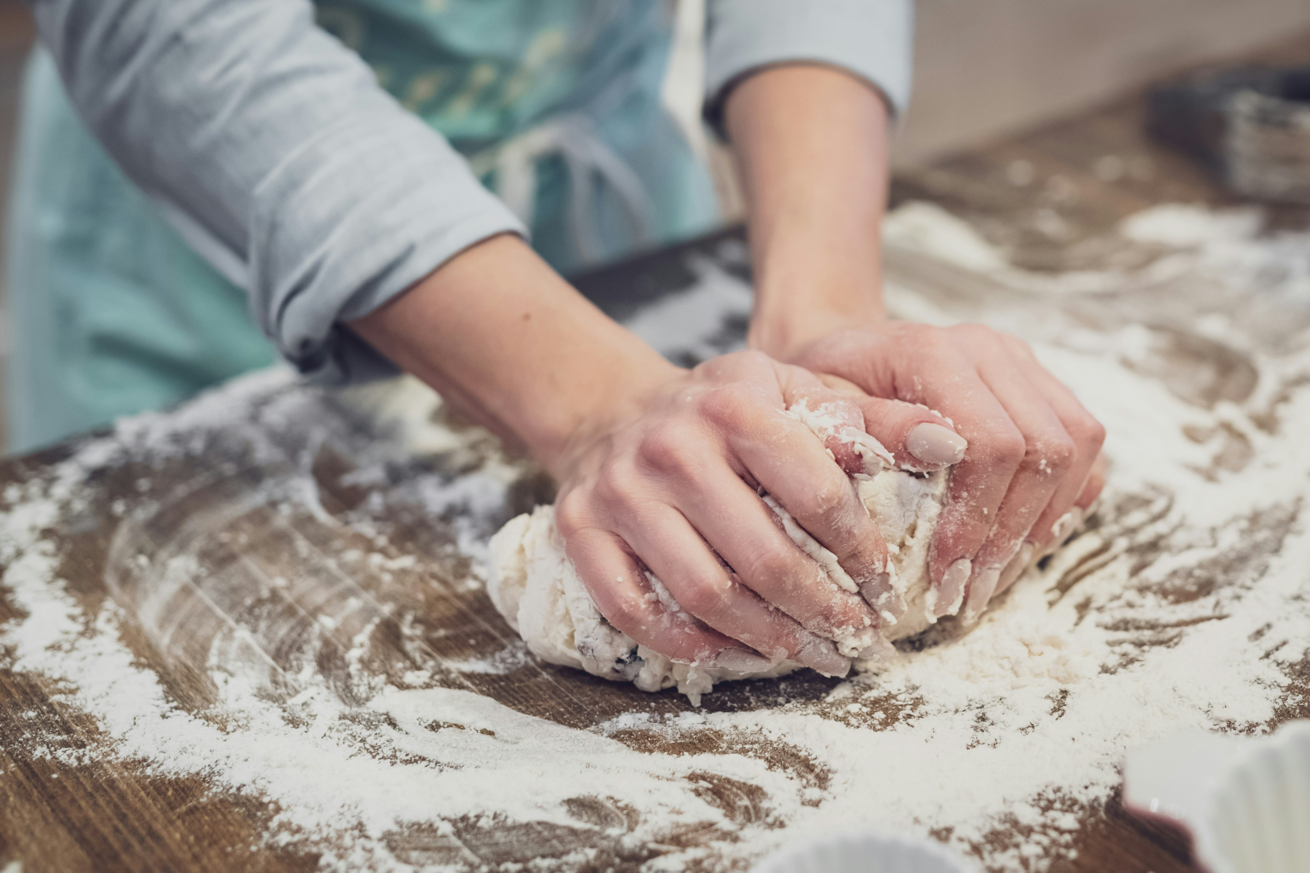 Someone kneading dough for baking