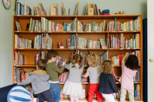 Kids looking through a large bookcase