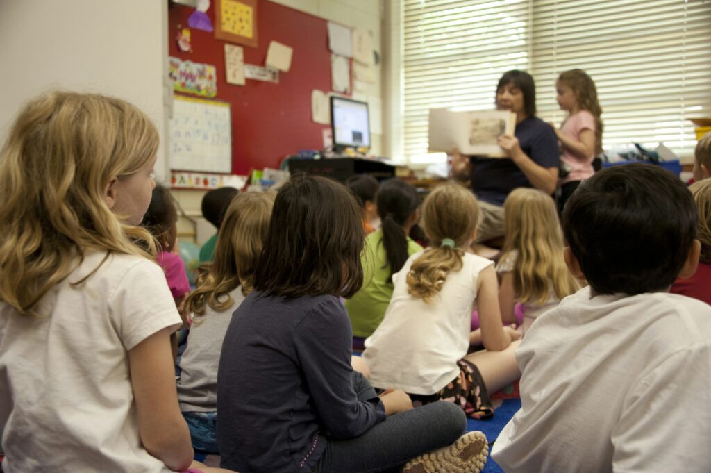Students listening to their teacher read them a story