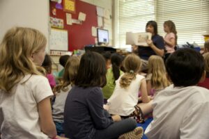 Students listening to their teacher read them a story