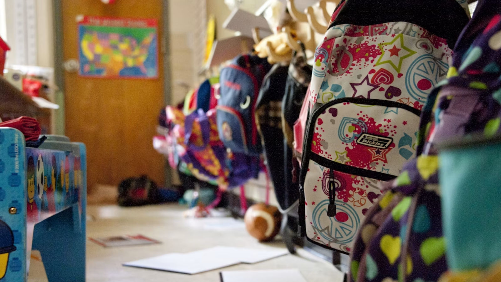 A row of backpacks in a preschool