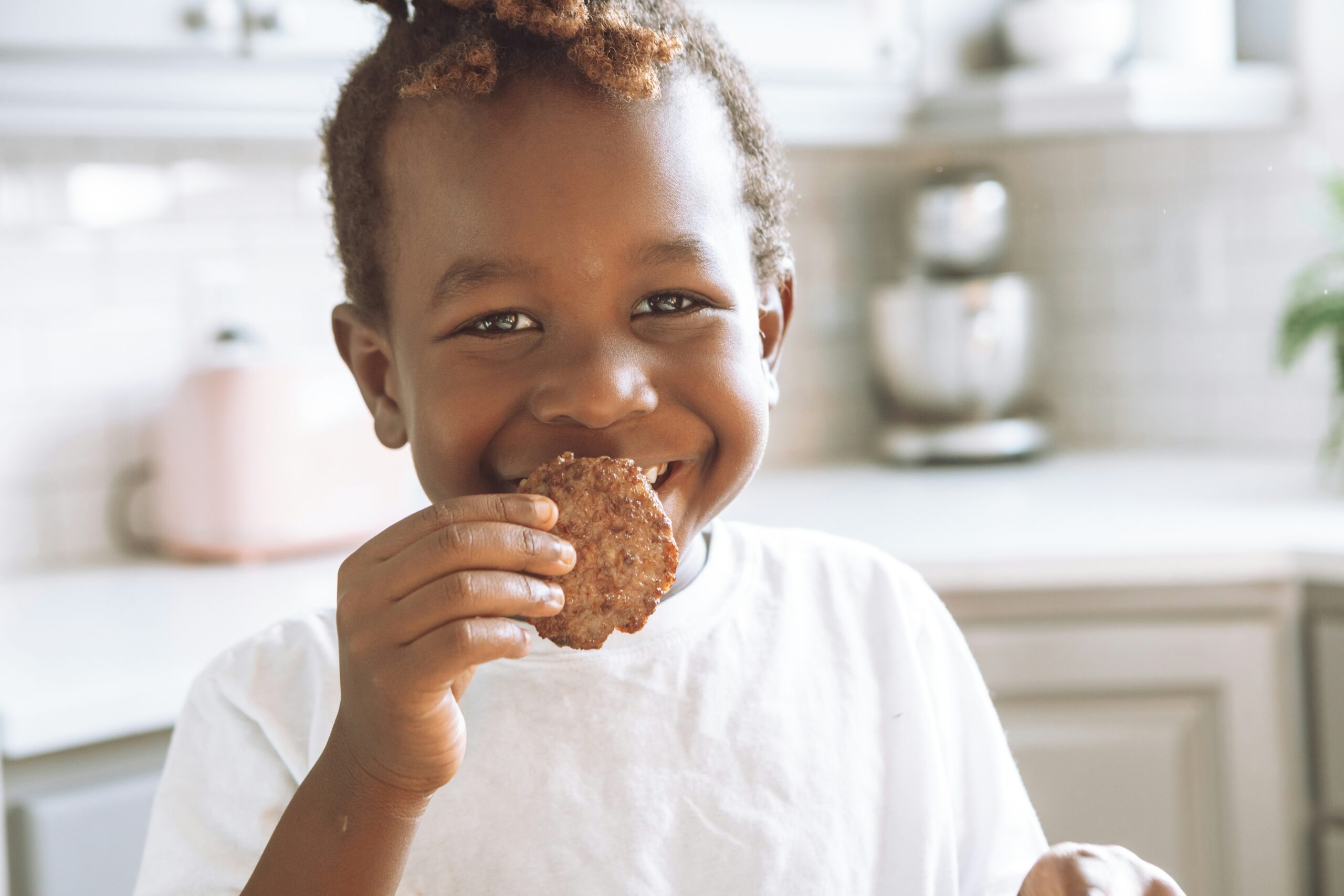 A kid eating a sausage